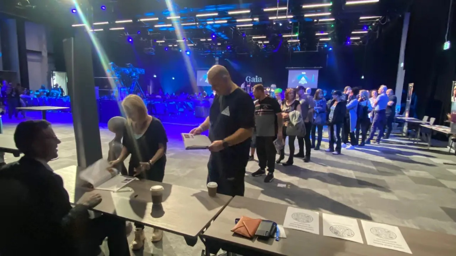 A long lineup of attendees waiting to meet Jonny Enoch at his conference table