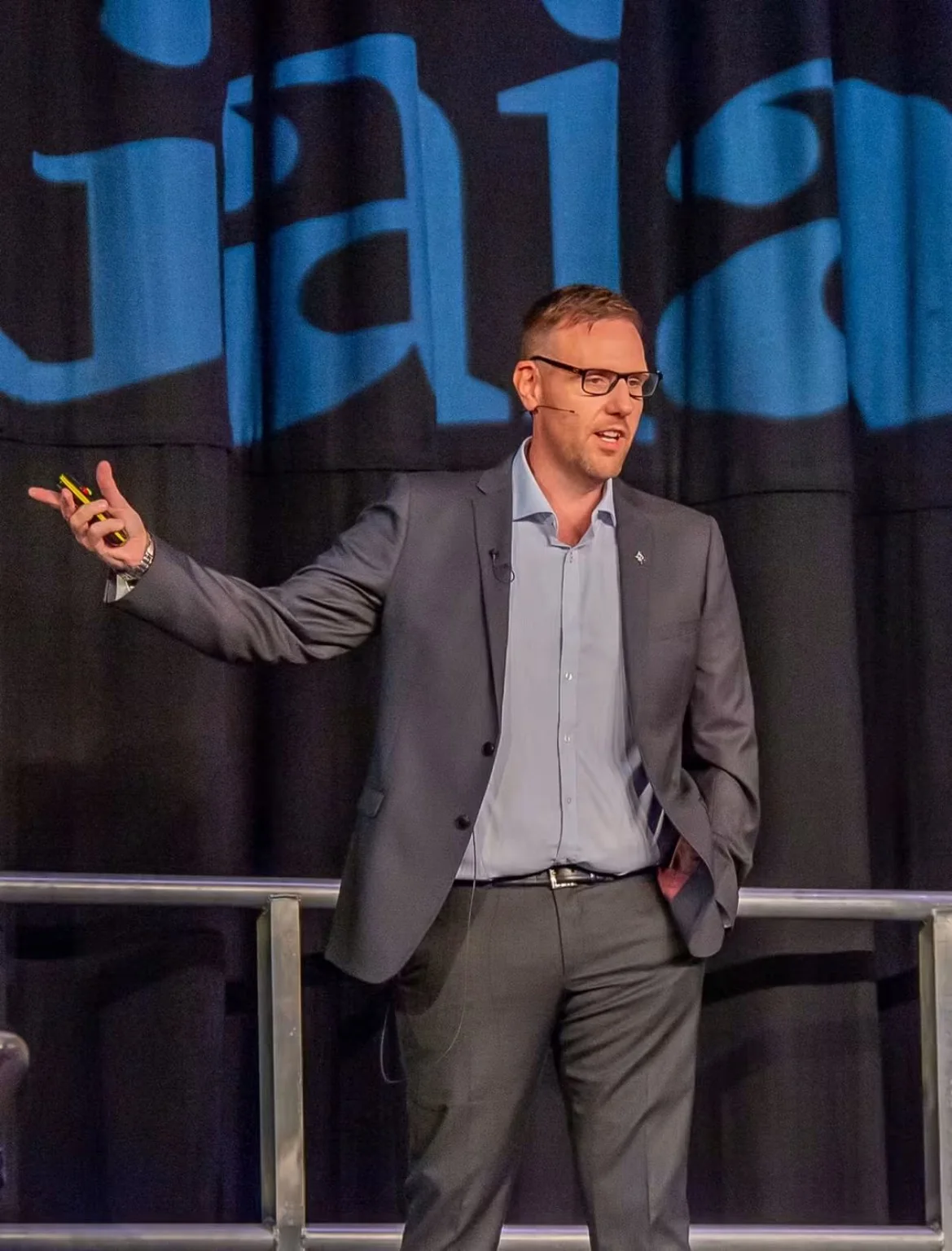 Jonny Enoch addressing an audience on stage